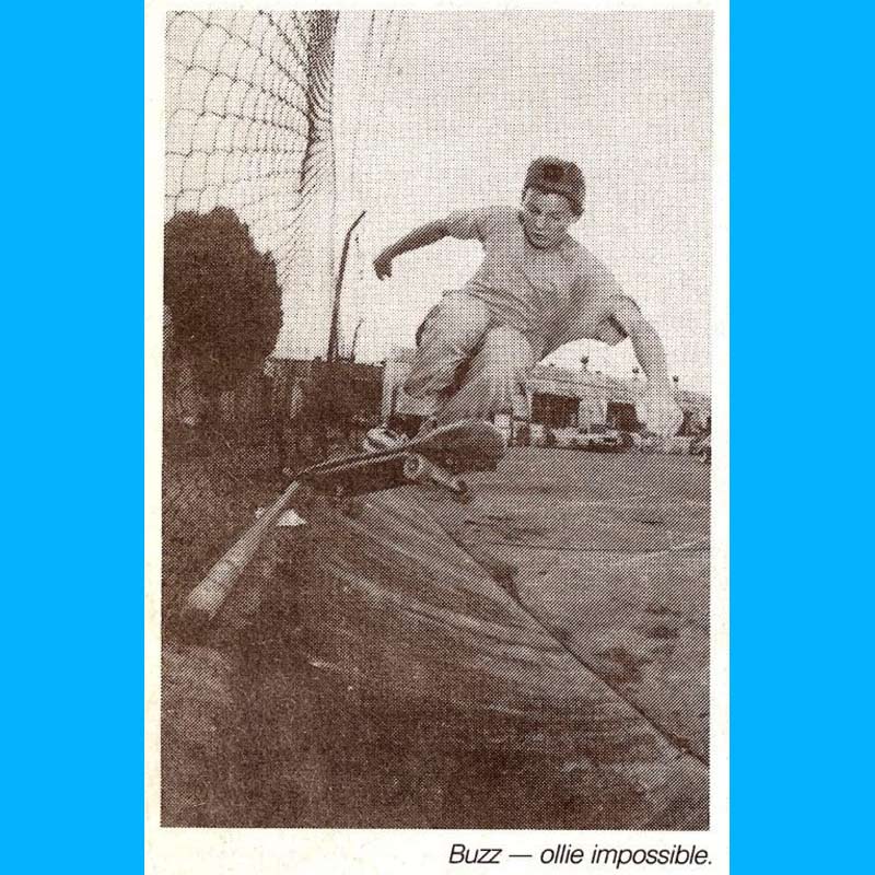 Jason Burrows wearing a baseball cap backwards - Performing an Ollie Impossible on a rough concrete embankment.