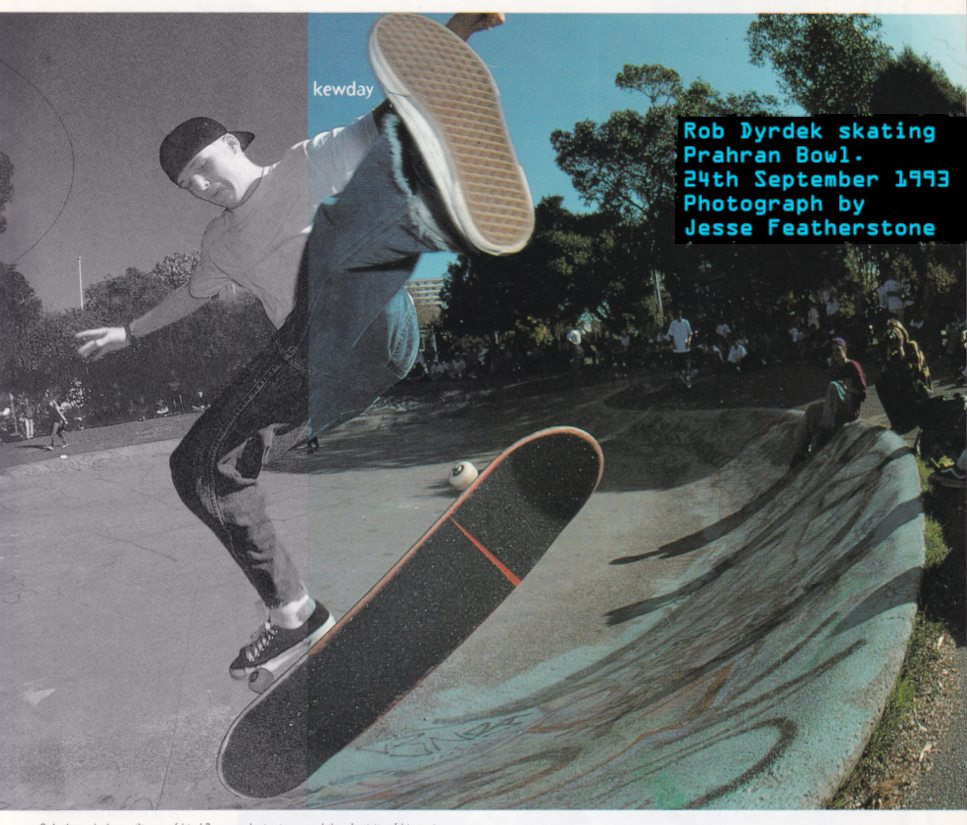 Iamge of Rob Dyrdek wearing 90s skate fashion... A fitted baseball cap backwards, baggy jeans and Vans shoes.
    He is performing a big Frontside Nollie Heelflip on a bright sunny day at Prahran Bowl. A large crowd of spectators sitting around the bowl
    watch in amazement.