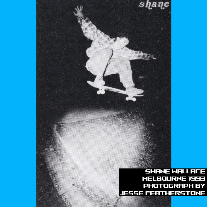 Image taken at nighttime of Shane doing a long distance Ollie over an area of grass in between driveways.
    Shane is wearing a flannel shirt and loose-fitting clothing.